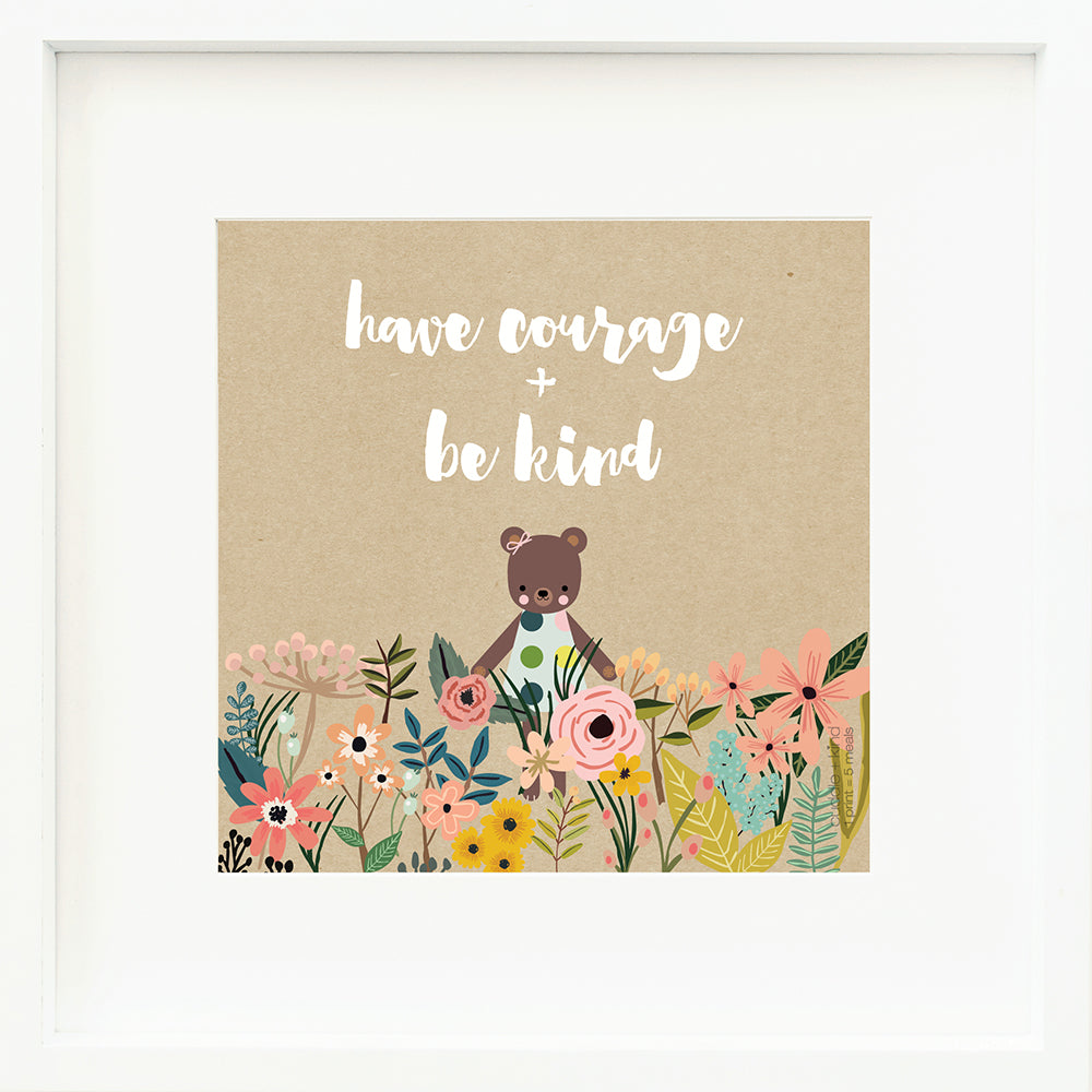 A framed print with a drawing of Ivy the bear and text that says āHave courage + be kind.ā