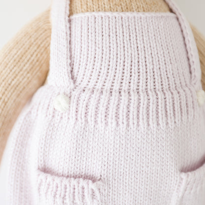 A close-up showing the real pocket details on Olivia's lavender apron dress.