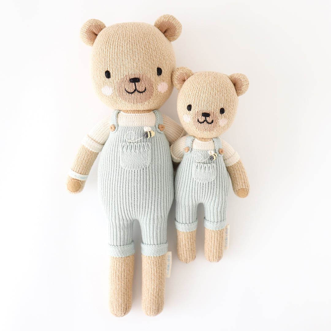 Regular and little Charlie the honey bear stuffed dolls with their arms around each other.