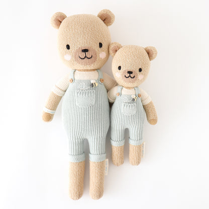 Regular and little Charlie the honey bear stuffed dolls with their arms around each other.