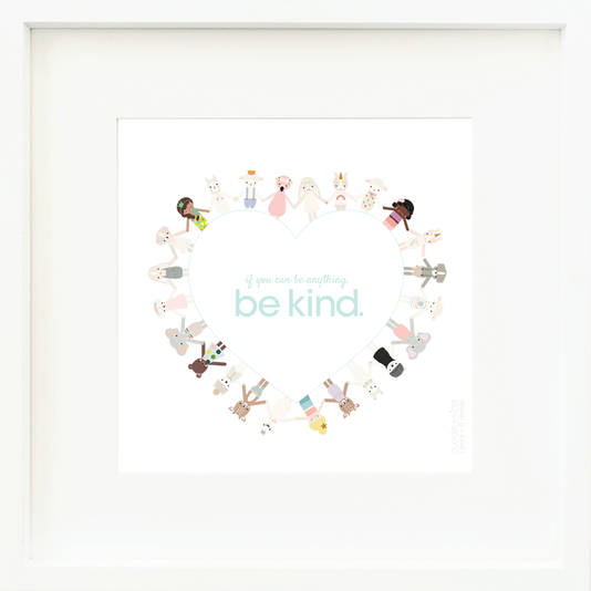 An inspirational print with the words “If you can be anything, be kind” in blue letters inside a heart. Graphics of cuddle and kind dolls holding hands surround the edges of the heart. The background of the print is white.