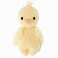 A cuddle and kind doll from the baby animal collection, baby duckling, shown from the front. Baby duckling is yellow with fluffy wings and a tuft of feathers on its head. 