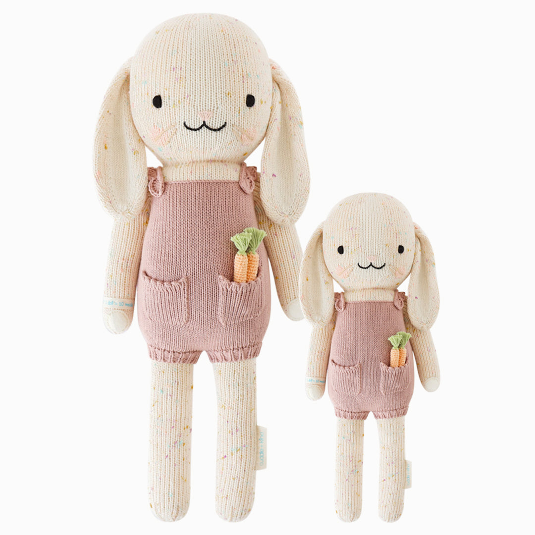 Harper the bunny in the regular and little sizes, shown from the front. Harper is wearing a mauve jumper, with two knitted carrots peeking out of her pocket.