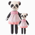 Polly the panda in the regular and little sizes, shown from the front. Polly is wearing a colorblock dress and has a hand-knit flower on her ear.