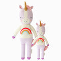 Zoe the unicorn in the regular and little sizes, shown from the front. Zoe is purple, and her shirt has a rainbow on it.