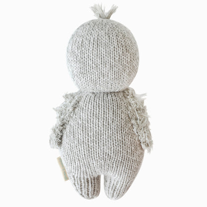 The baby penguin doll shown from the back.