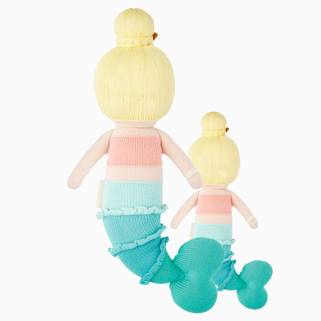 Cuddle and kind doll Skye the mermaid in the regular and little sizes, shown from the back.