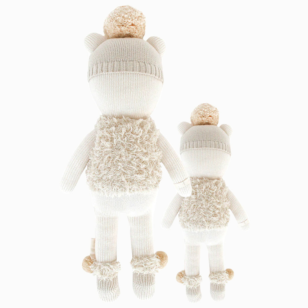 Cuddle and kind doll Stella the polar bear in the regular and little sizes, shown from the back.