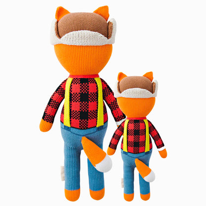 Cuddle and kind doll Wyatt the fox in the regular and little sizes, shown from the back. Wyatt’s tail is poking out the back of his pants.