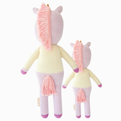 Cuddle and kind doll Zoe the unicorn in the regular and little sizes, shown from the back. Zoe has a pink tasselled mane and tail.