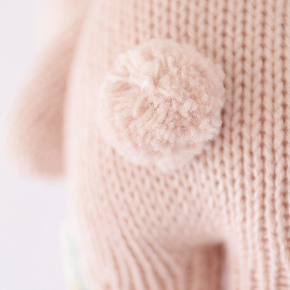 A close up showing baby bunny in rose’s fluffy cotton tail. 