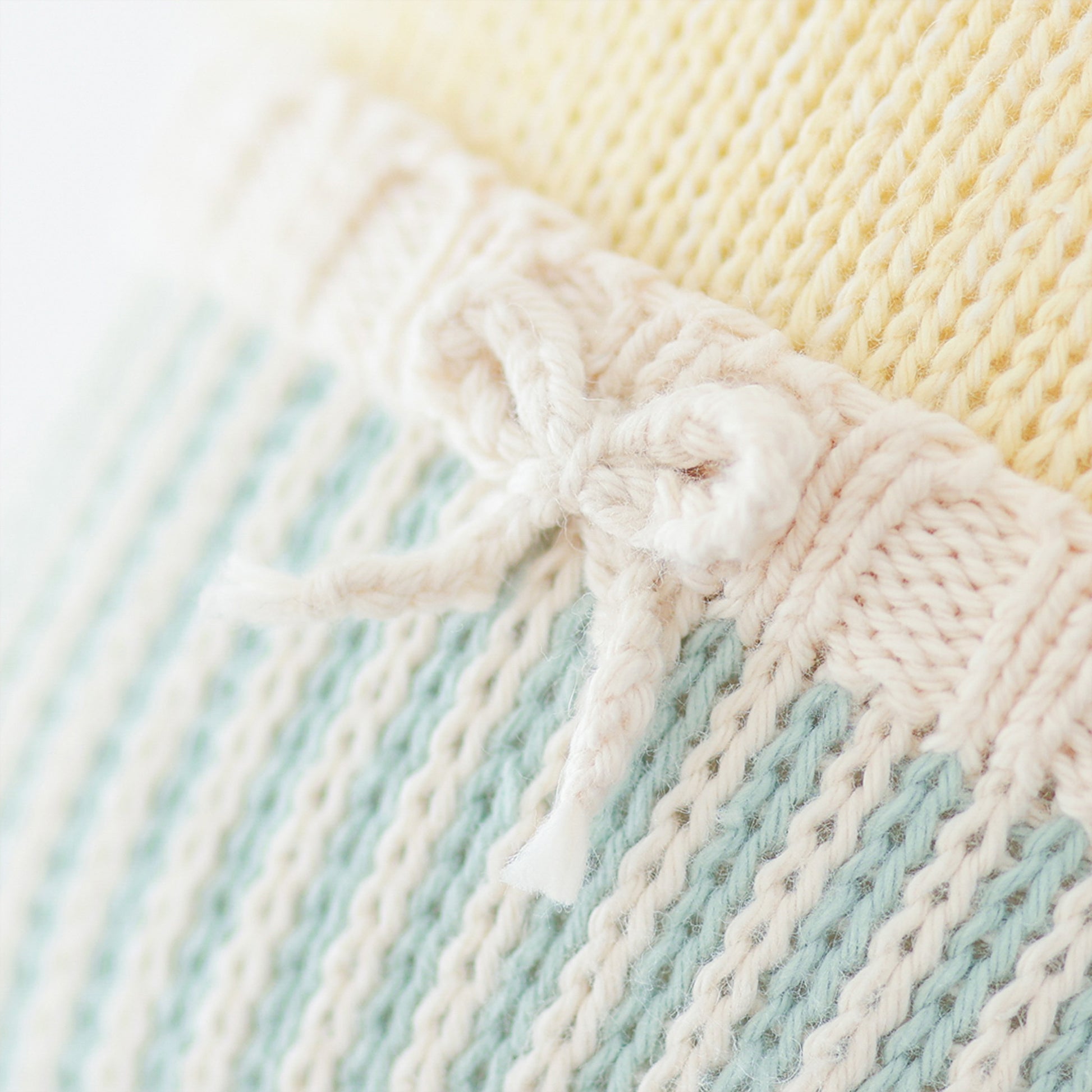 A close-up showing the hand-knit details on Finley the duckling’s swim trunks.