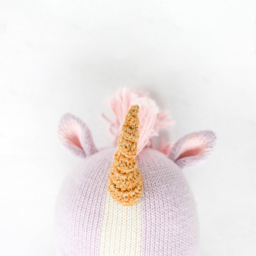 A close-up showing Zoe the unicorn’s horn, with white yarn woven among golden brown yarn.