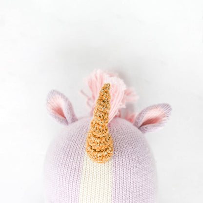 A close-up showing Zoe the unicorn’s horn, with white yarn woven among golden brown yarn.