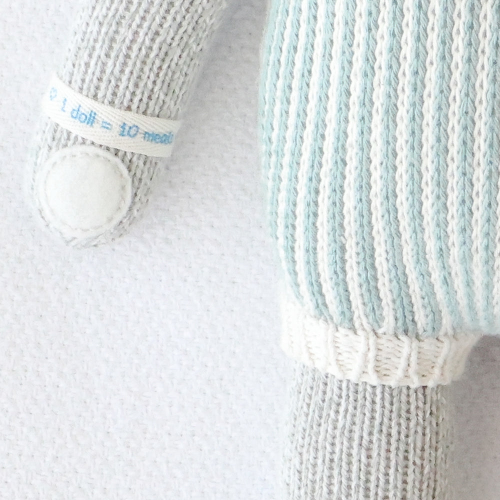 A close-up showing hand-knit details on Dylan the kitten.