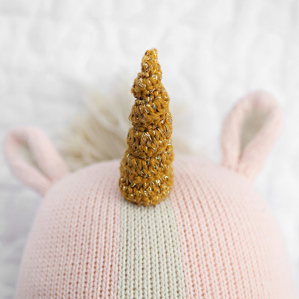 A close-up showing Ella the unicorn’s horn, with white yarn woven among brown yarn.