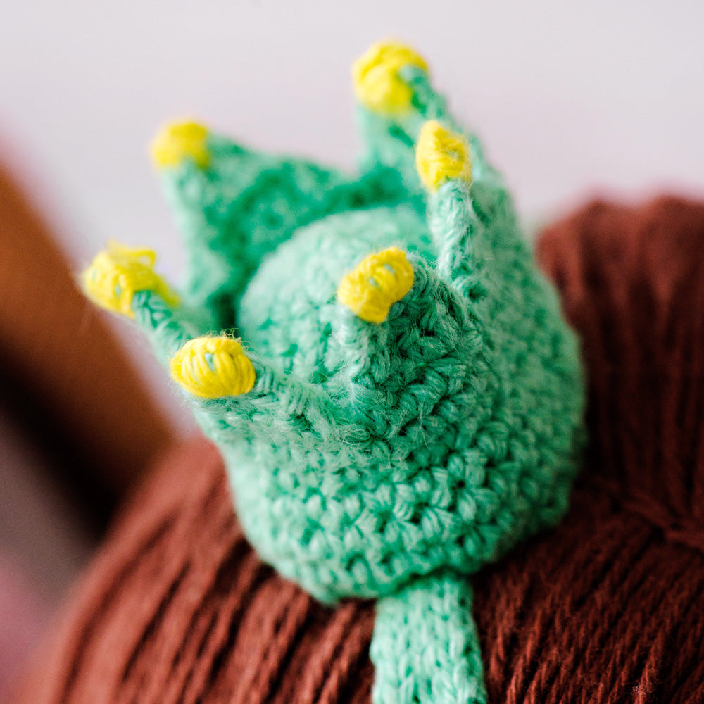 A close-up showing Pearl’s hand-knit crown headband.