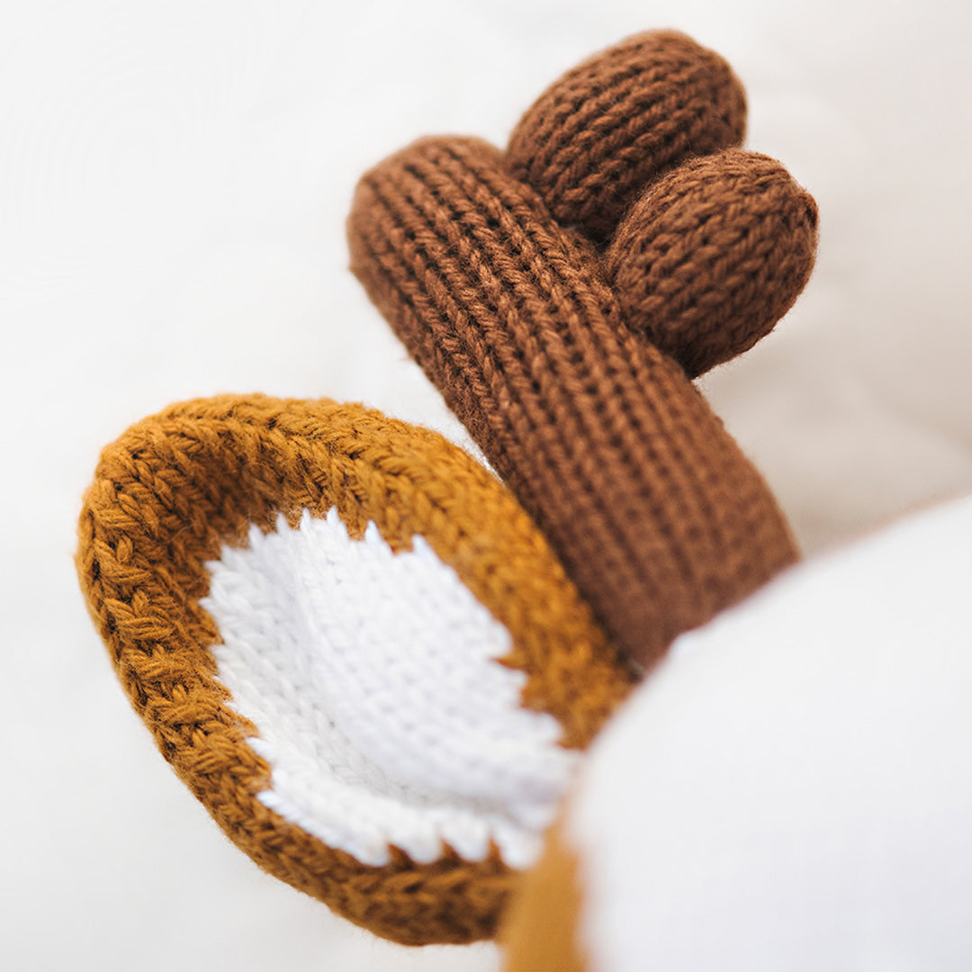 A close-up showing Scout the deer’s hand-knit ear and one of his antlers.