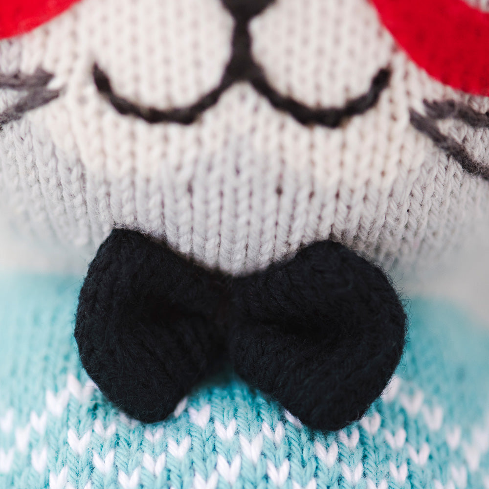 A close-up showing Benedict the bunny doll’s hand-knit bow tie.