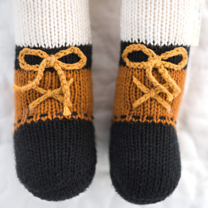 A close-up showing Hudson’s boots, with laces made out of yarn.