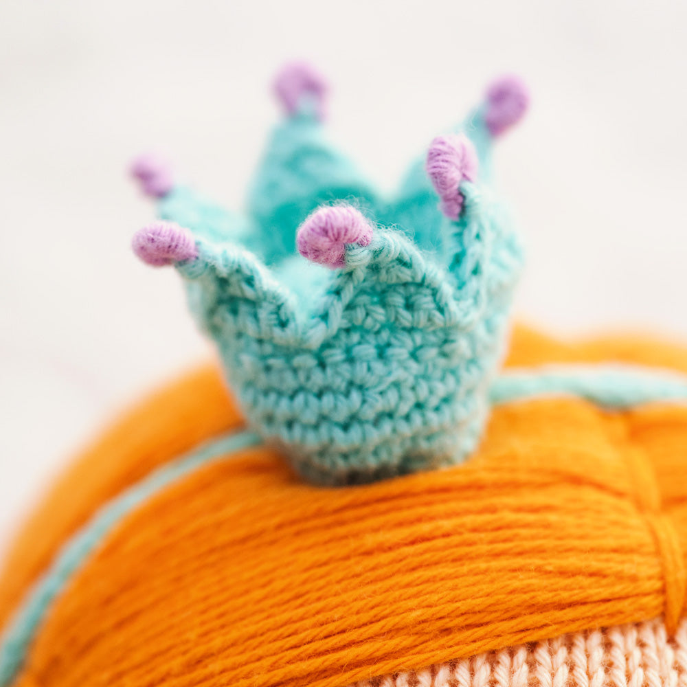 A close-up showing Isla’s hand-knit crown headband.