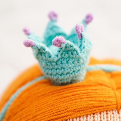 A close-up showing Isla’s hand-knit crown headband.