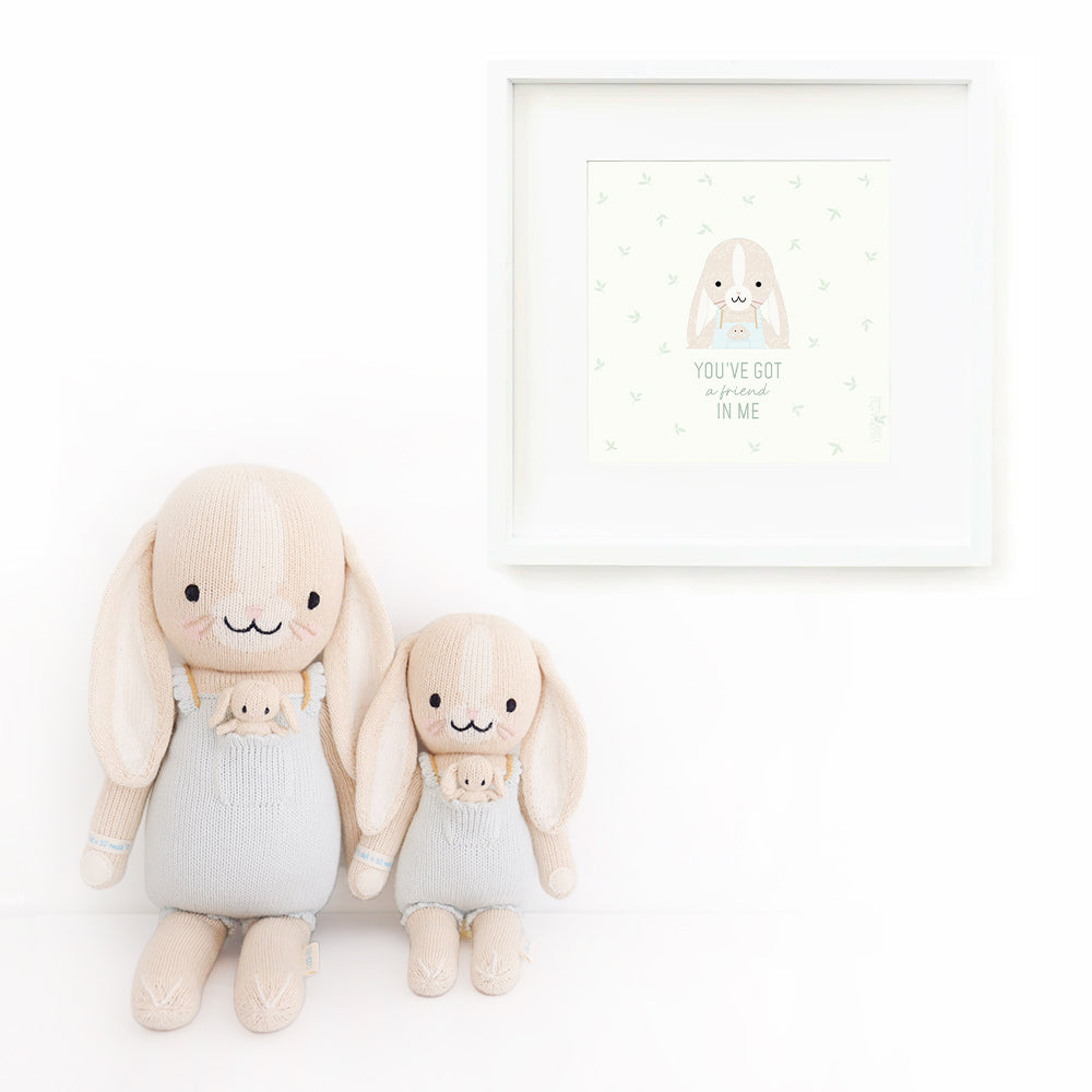 Two Briar the bunny stuffed dolls sitting beside a framed print with a picture of Briar that says “You’ve got a friend in me.”