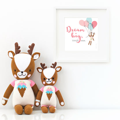 Two Willow the deer stuffed animals sitting beside a framed print with a picture of Willow that says “Dream big, little one.”