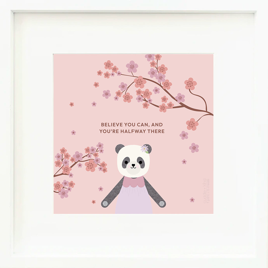 A framed print with a drawing of Polly the panda, with text that says "Believe you can, and you’re halfway there."