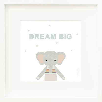 A framed print with a drawing of Evan the elephant and text that says “Dream big.”