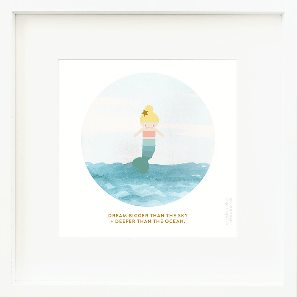 A framed print with a drawing of Skye the mermaid and text that says “Dream bigger than the sky + deeper than the ocean.”