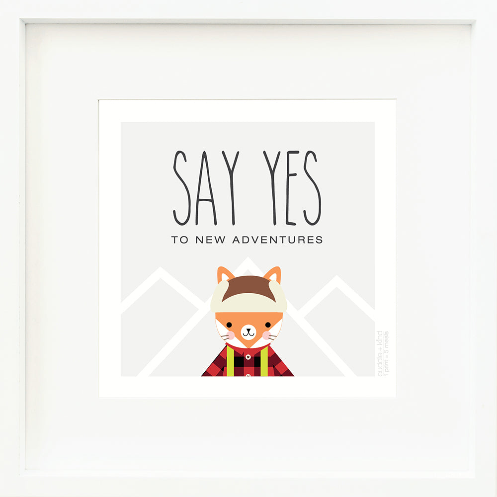 A framed print with a drawing of Wyatt the fox and text that says “Say yes to new adventures.”