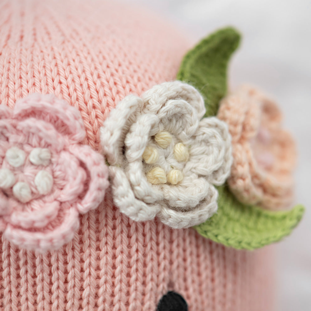 A close-up showing Penelope the flamingo’s embroidered flower crown.