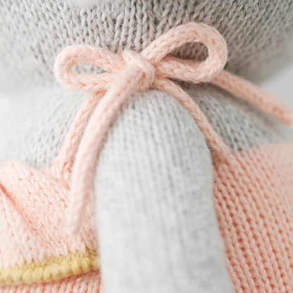 A close-up showing a bow on the shoulder of Eloise’s romper.