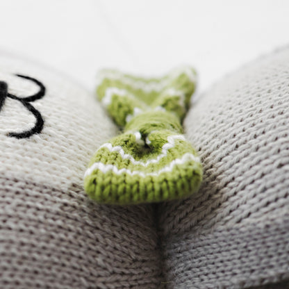 A close-up showing Noah the dog’s hand-knitted bow-tie, which is green with white stripes.