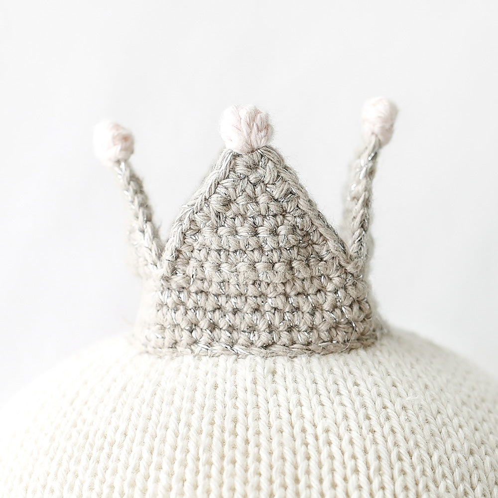 A close-up showing Harlow’s hand-knitted crown.