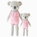 Claire the koala in the regular and little sizes, shown from the front. Claire is wearing a pink romper with ruffles.