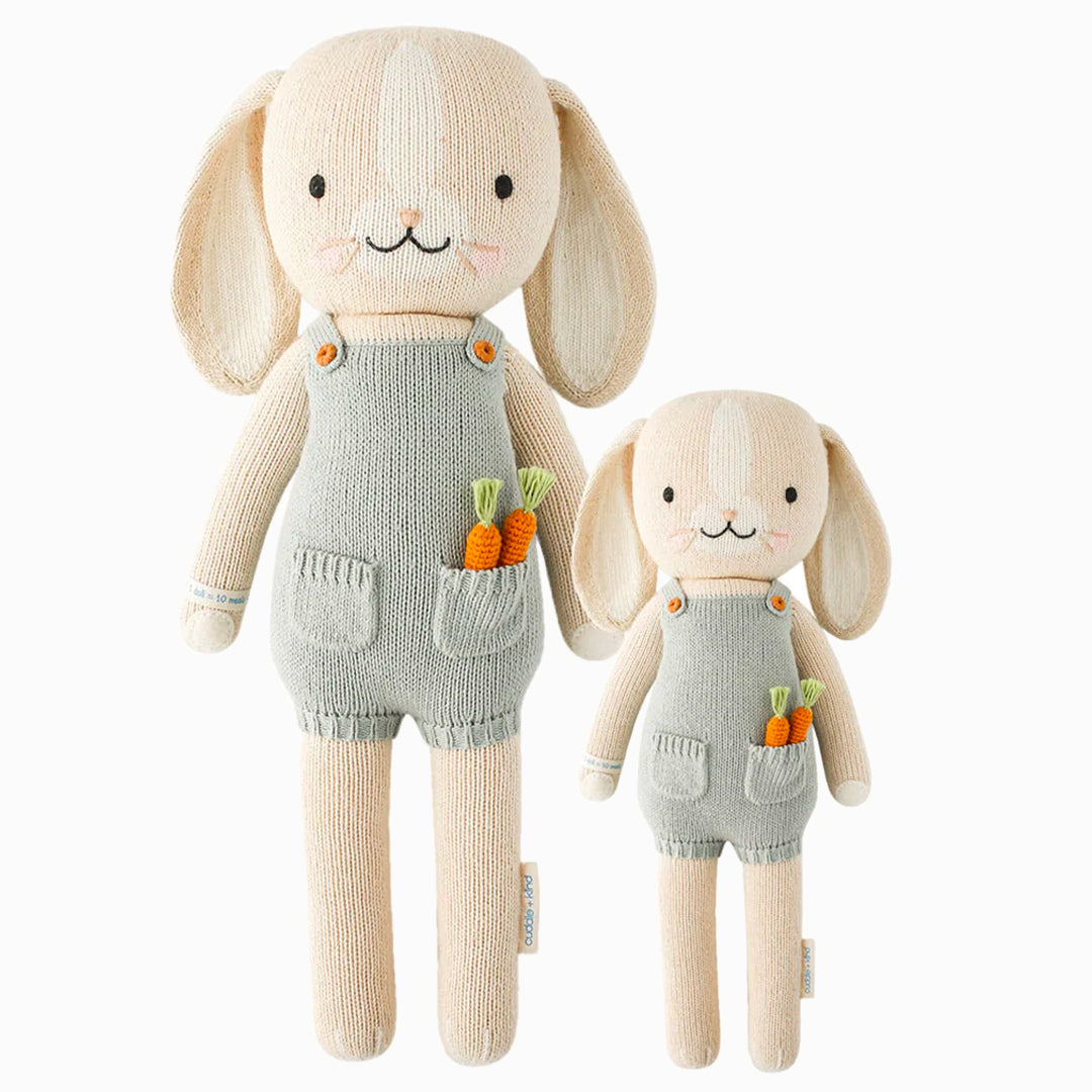 Henry the bunny in the regular and little sizes, shown from the front. Henry is wearing blue overalls, with two knitted carrots peeking out of his pocket.