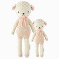 Lucy the lamb in the regular and little sizes, shown from the front. Lucy has a pastel pink outfit with polka dots and a pastel pink yarn bow.