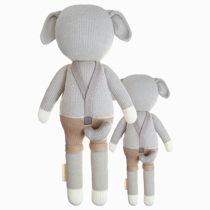 Cuddle and kind doll Noah the dog in the regular and little sizes, shown from the back. Noah’s tail is poking out the back of his shorts.