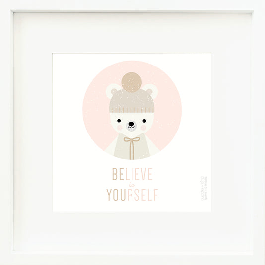 An inspirational print with a graphic of Stella the polar bear in a pink circle on a white background with the words “Believe in yourself” in pink and brown.