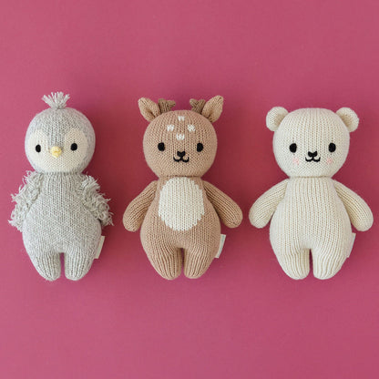 A group of three baby animal stuffed dolls: baby fawn, baby penguin and baby polar bear.